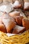 Mandazi, also known as theÂ daboÂ orÂ South Sudanese Coconut Doughnut close-up in a basket. Vertical